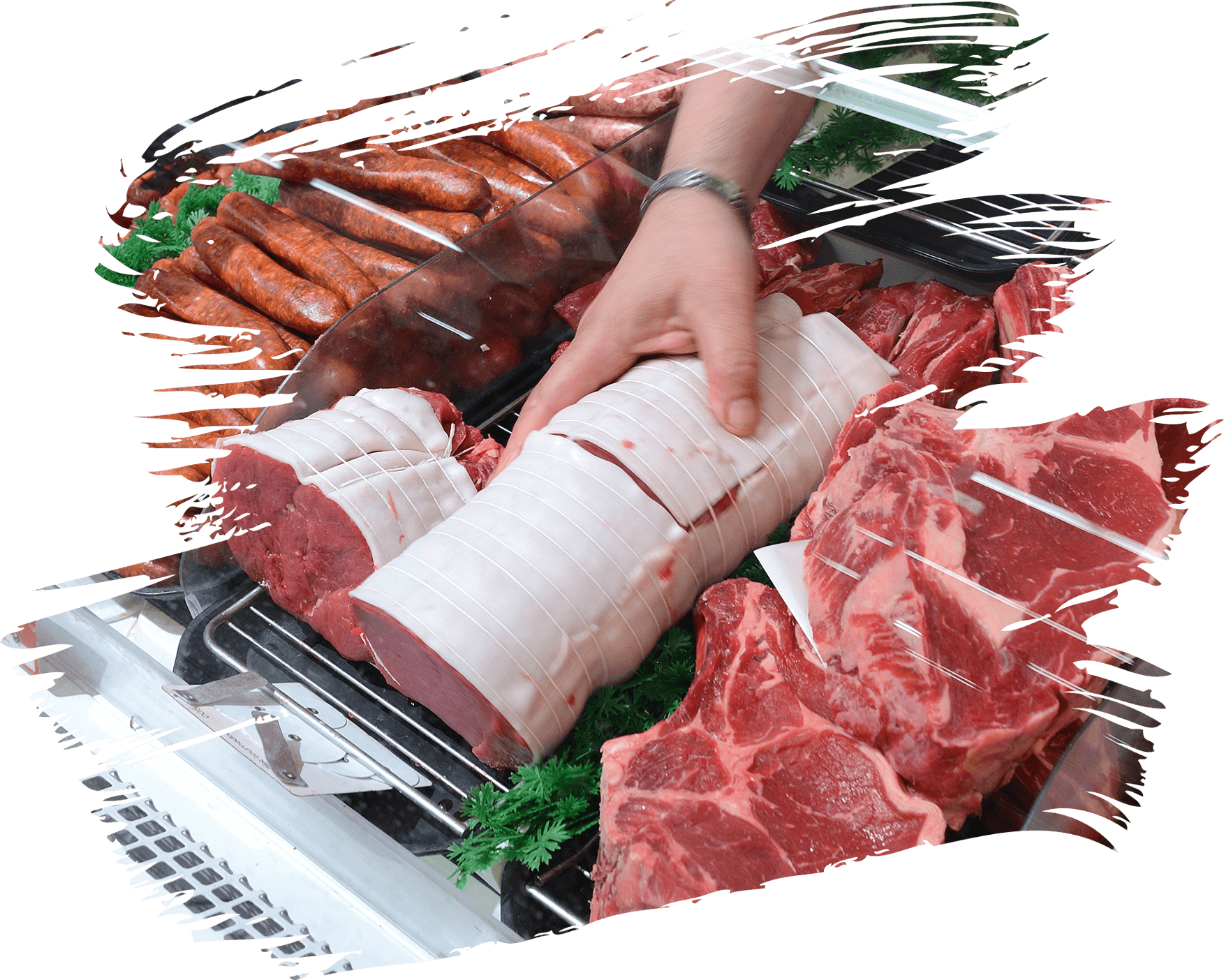 Butcher arranging cuts of beef and sausages in a display case