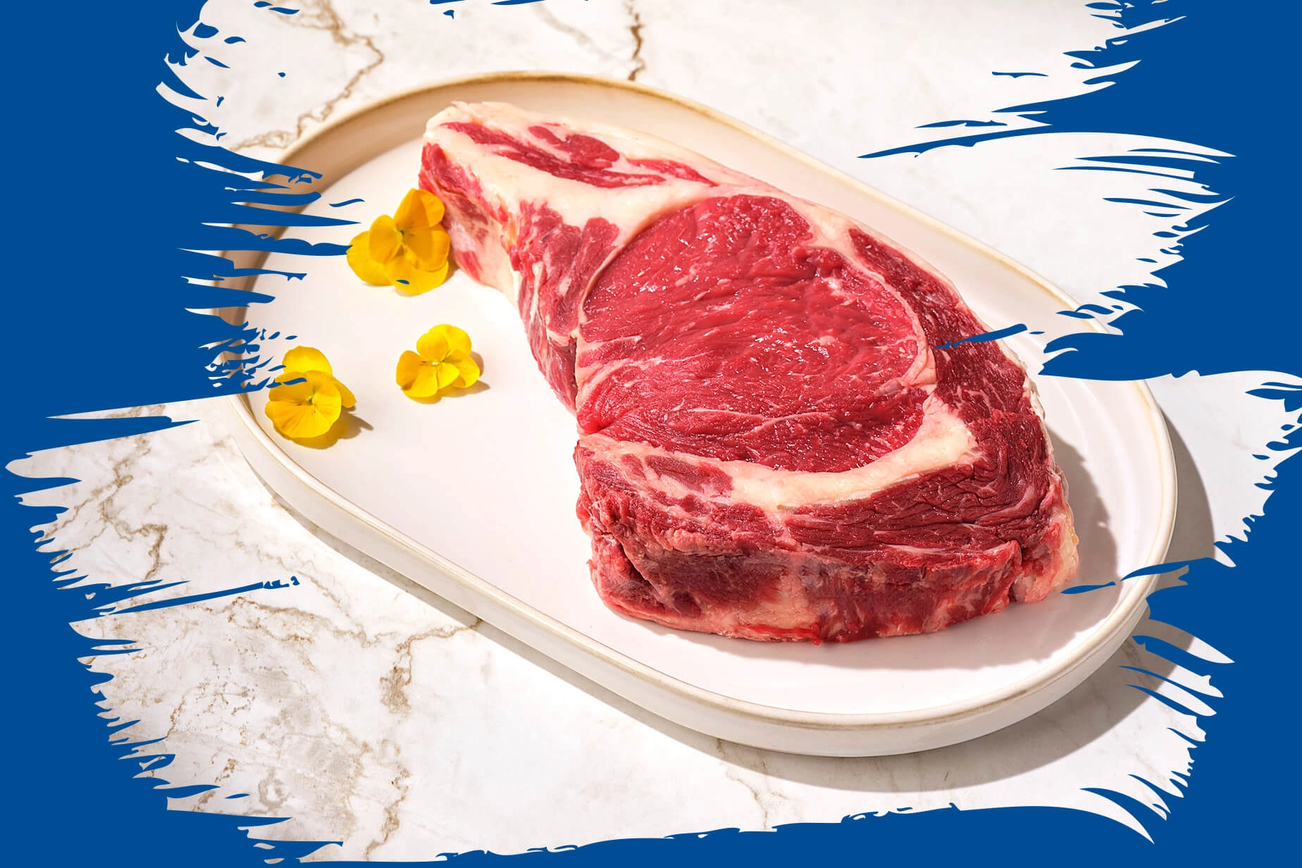Raw ribeye steak on a white plate with yellow flowers